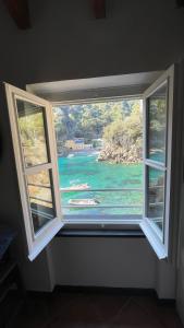 a window with a view of a body of water at Casa dell'Arco Civico 35 in San Fruttuoso