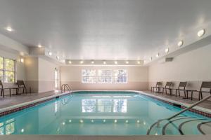 a large swimming pool with chairs in a building at Residence Inn Sacramento Rancho Cordova in Rancho Cordova