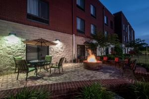 a patio with a table and chairs and a fire pit at SpringHill Suites Statesboro University Area in Statesboro