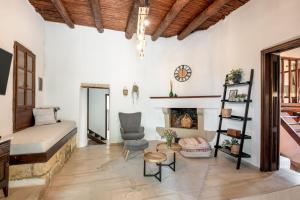 a bedroom with a bed and a fireplace at Joel Living Collection - Rustic Villa in Áptera