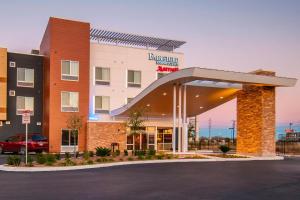 a hotel front of a building with a parking lot at Fairfield Inn & Suites by Marriott San Antonio Brooks City Base in San Antonio