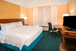 a hotel room with a bed and a desk and a computer at Fairfield Inn & Suites by Marriott San Antonio Brooks City Base in San Antonio