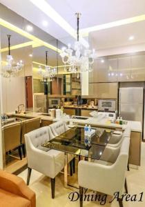 a large kitchen with a glass table and chairs at Dorsett Residences Bukit Bintang in Kuala Lumpur