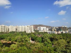 a view of a city with tall buildings and trees at Maxxvalue Apartment Chandivali in Mumbai
