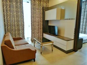 a living room with a couch and a tv and a mirror at Dorsett Residences Bukit Bintang in Kuala Lumpur