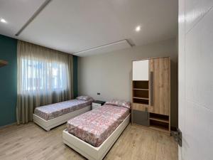 a bedroom with two beds and a cabinet in it at Casa Marina Smir in Marina Smir +15 photos