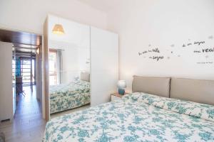 a bedroom with two beds and a mirror at Casa Pace Stintino in Stintino
