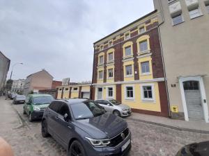 um grupo de carros estacionados em frente a um edifício em ORKANA House em Olsztyn