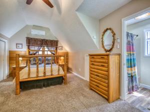 een slaapkamer met een houten stapelbed en een dressoir bij Pets! 2 Fireplaces! Game Room! Creek! View! in Maggie Valley