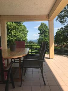 a table and chairs on a patio with a view at Ferienhaus Westerbuchberg in Übersee