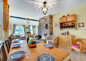 a dining room with a table with wine glasses at Chy An Porth in Padstow