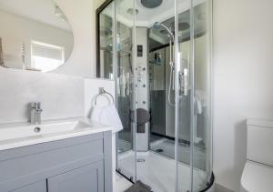 a bathroom with a glass shower and a sink at Bishops Hill in Acomb