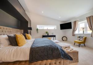 a bedroom with a large bed and a tv at Bowjy in Menheniot