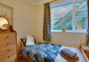 a small bedroom with a bed and a window at Sammys Place in Hexham