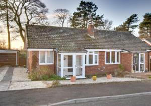 a red brick house with white doors and windows at Endar in Tweedmouth