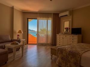 a bedroom with a bed and a view of the ocean at Hawaii Hotel in Marmaris