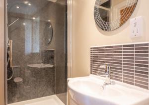 a bathroom with a sink and a shower at The Barns in Ellingham