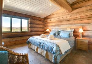 a bedroom with a bed in a log cabin at Mount Hooley Lodge in Alston