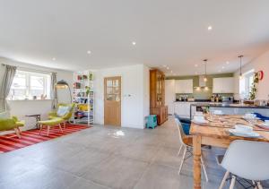 a kitchen and living room with a table and chairs at Under The Stars in Chatton
