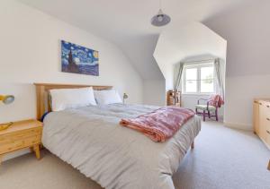 a bedroom with a large bed and a window at Under The Stars in Chatton