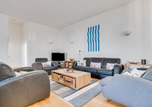 a living room with couches and a coffee table at Kirkside in Embleton