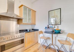 a kitchen with a counter and a table with chairs at Kirkside in Embleton