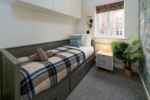 a bedroom with a bed and a window at Ideal Lodgings In Openshaw in Manchester