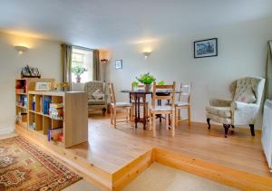 a living room with a table and a dining room at Braeside in Wooler