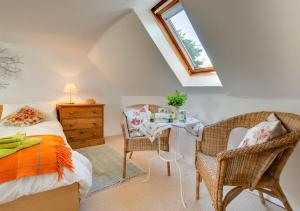 a bedroom with a bed and a table and chairs at Braeside in Wooler