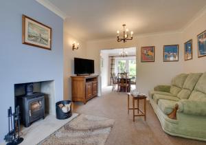 a living room with a couch and a fireplace at Moraine in Ravenscar