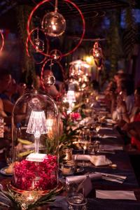 a long table with flowers and lights on it at Chandra Residence in Chiang Mai