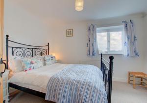 a bedroom with a bed and a window at Millies in Padstow