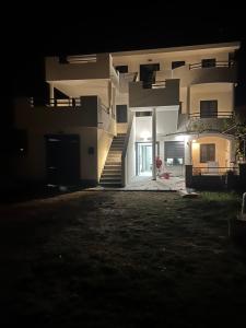 a night view of a large house with a staircase at Apartments Linic in Nin