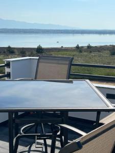 a ping pong table and a chair sitting on a roof at Apartments Linic in Nin
