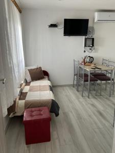 a bedroom with a bed and a table with chairs at Apartments Linic in Nin