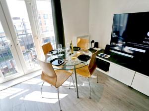 a dining room with a glass table and chairs at Pass the Keys Free Parking Central Apartment in Manchester