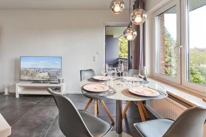 a dining room with a table and chairs and a tv at Haus Deepensoll 39 Ankerplatz in Pelzerhaken