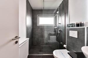 a bathroom with a shower and a toilet and a sink at Haus Deepensoll 39 Ankerplatz in Pelzerhaken +24 photos