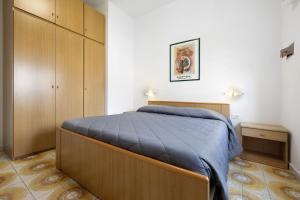 a bedroom with a large bed and a cabinet at Numero 14 in Borgio Verezzi