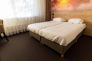 Postel nebo postele na pokoji v ubytování Hotel de Stoppelberg
