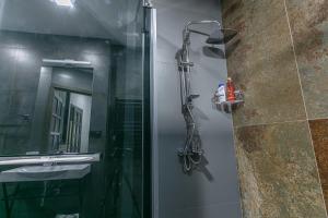 a shower in a bathroom with a glass door at Luxe Apartment in Center in Yerevan