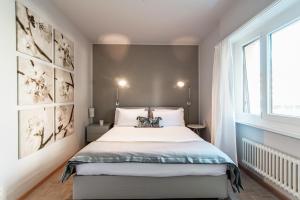 1 dormitorio con cama y ventana en Agave Apartment by Quokka 360 - flat with large terrace in Lugano, en Viganello