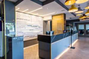 a restaurant lobby with a large sign in the background at Premier Inn Saarbrücken City Centre in Saarbrücken