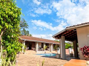 a house with a swimming pool and a patio at Chez Vincent in Nelspruit