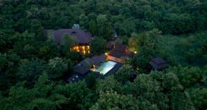 an aerial view of a house in the middle of a forest at Chandra Residence in Chiang Mai