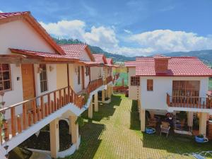 a row of houses with balconies and a courtyard at Villas Montelindo in Constanza
