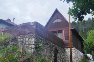 a house on top of a stone wall at Romanticka chata pre hostí s ohniskom in Spišská Nová Ves