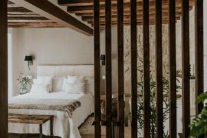 a bedroom with a white bed and a table at Puracepa - Urban Suites in Haro