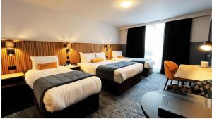 Voodi või voodid majutusasutuse Dublin Skylon Hotel toas