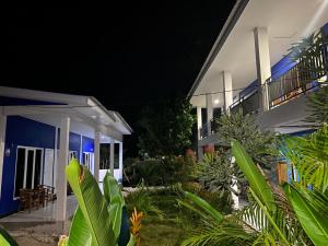 a house at night with a bunch of plants at Danke Lodge in Labuan Bajo